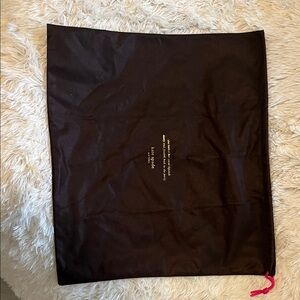 Kate spadeDark brown and gold draw string bag.